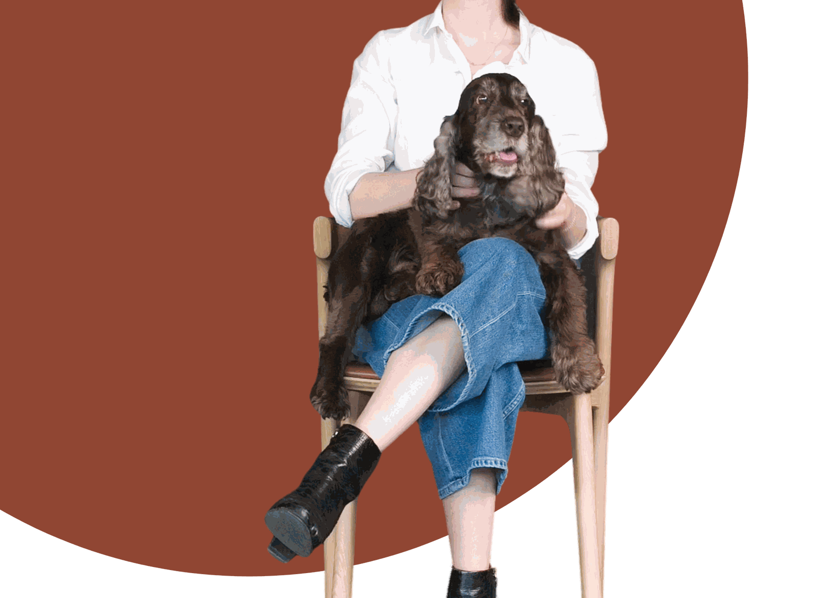 Live Light | Woman and dog enjoying Ethnicrafts famous Oak Bok Dining Chair with Cognac Leather
