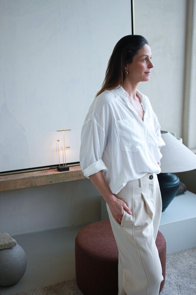 Live Light | Sofie Noyen in her living area with the Barrow lounge chair and Knokke table lamp in the back