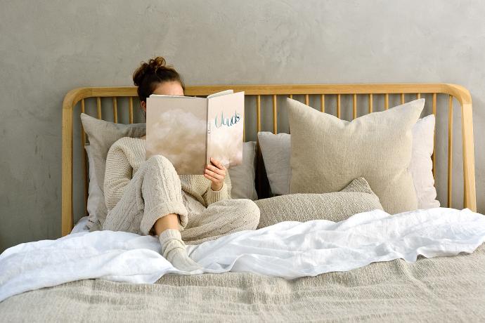 Bedroom with Spindle bed and person reading a book | Live Light